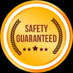 A gold badge with the words 'SAFETY GUARANTEED' in brown text, surrounded by a laurel wreath and three brown stars
