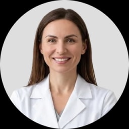 A smiling woman in a white lab coat against a light gray background